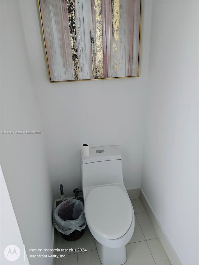 bathroom with toilet and tile patterned flooring