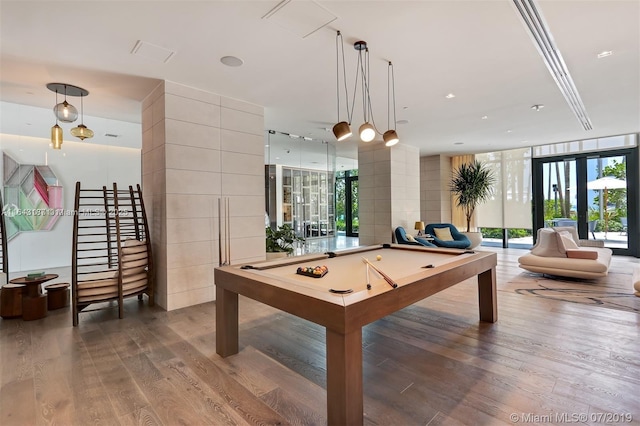 rec room with expansive windows, pool table, and hardwood / wood-style floors