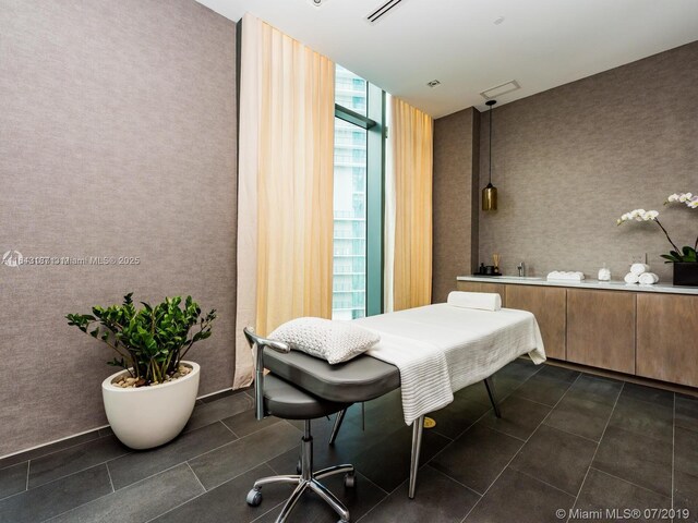 tiled bedroom with expansive windows