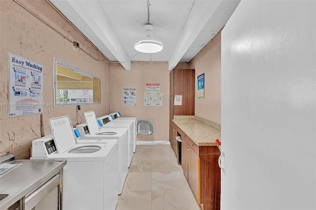 clothes washing area with washer and dryer