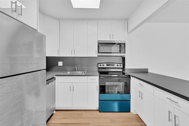 kitchen with sink, stainless steel appliances, light hardwood / wood-style floors, and white cabinets