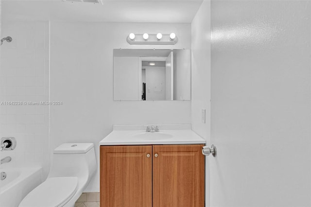 full bathroom featuring tiled shower / bath, vanity, and toilet