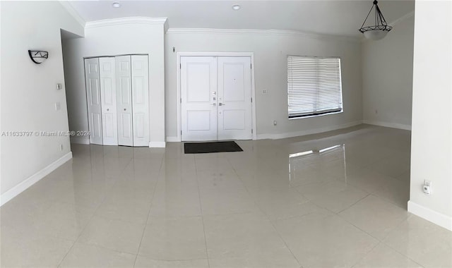 empty room featuring ornamental molding and tile patterned floors