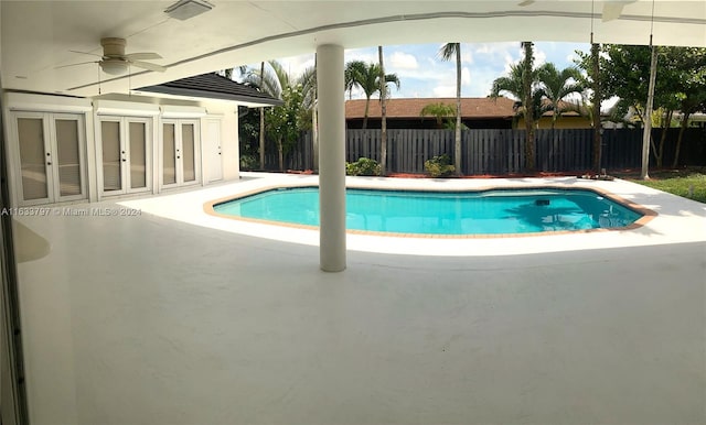 view of pool with ceiling fan and a patio