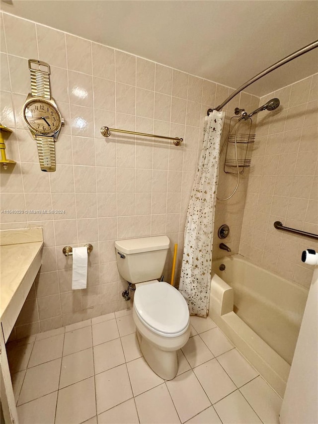 bathroom with tile walls, toilet, shower / bath combo, and tile patterned floors