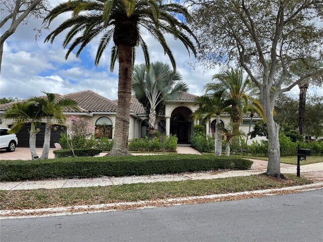 mediterranean / spanish-style home with a garage