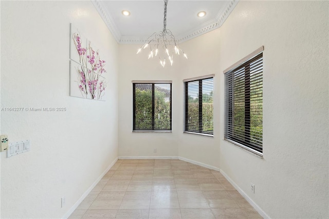 spare room with an inviting chandelier and ornamental molding