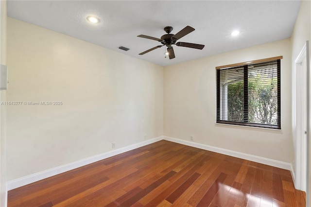 empty room with hardwood / wood-style flooring and ceiling fan