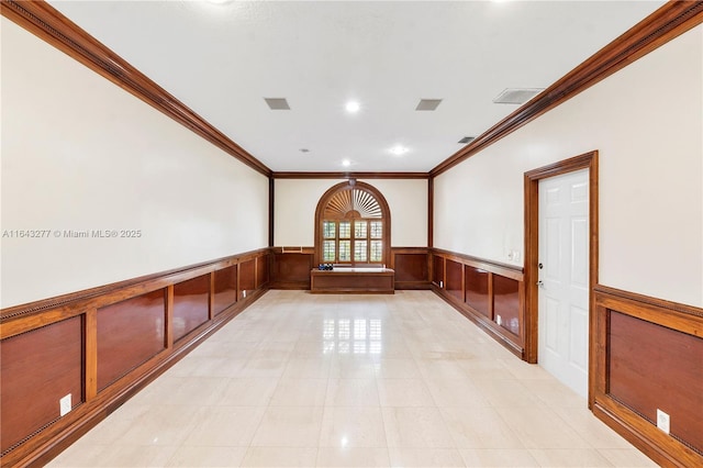 spare room featuring crown molding