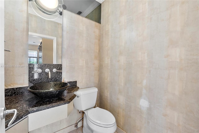 bathroom featuring vanity, tasteful backsplash, toilet, and crown molding