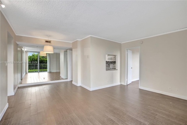 unfurnished living room with a textured ceiling, crown molding, and wood-type flooring