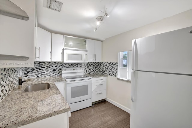 kitchen featuring sink, dark hardwood / wood-style flooring, light stone counters, white appliances, and white cabinets