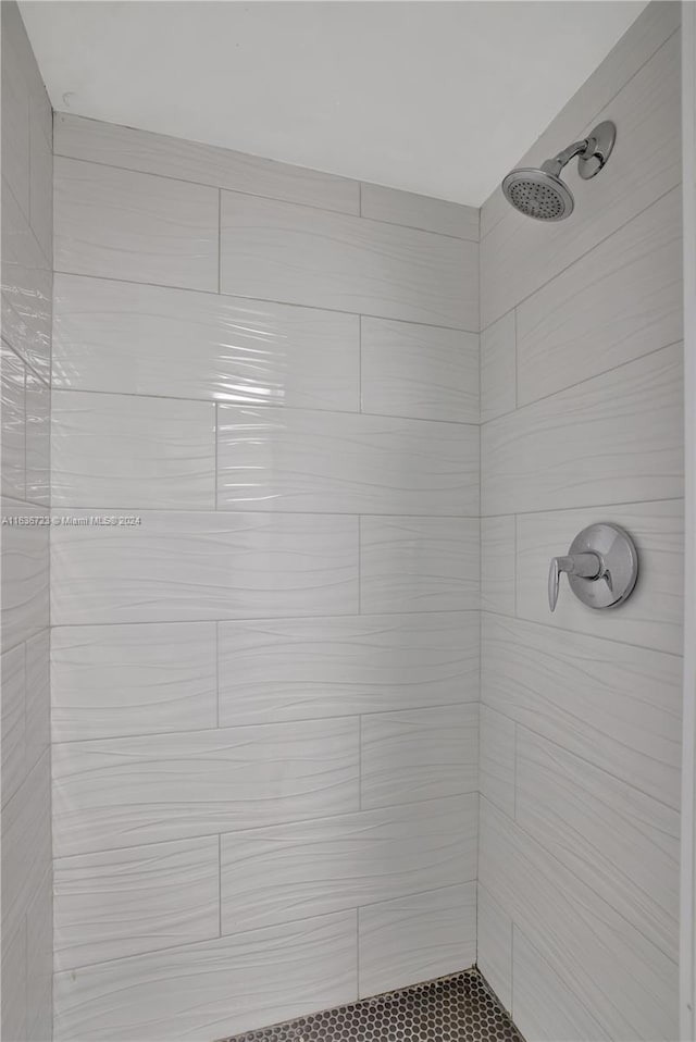 bathroom with tiled shower