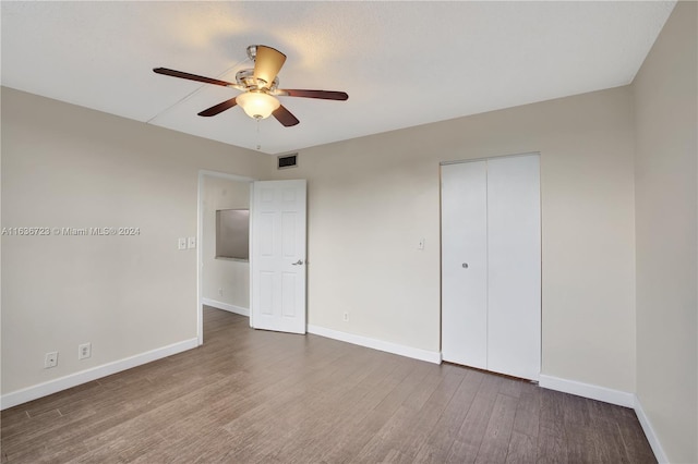 unfurnished bedroom with a closet, ceiling fan, and hardwood / wood-style floors