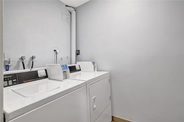 clothes washing area with separate washer and dryer