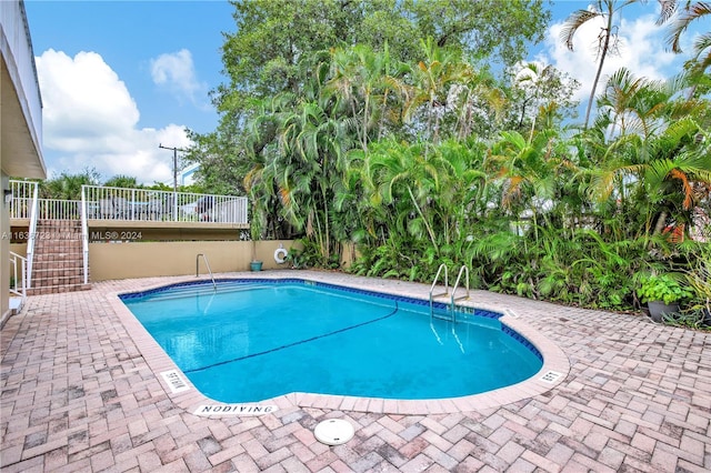 view of pool featuring a patio