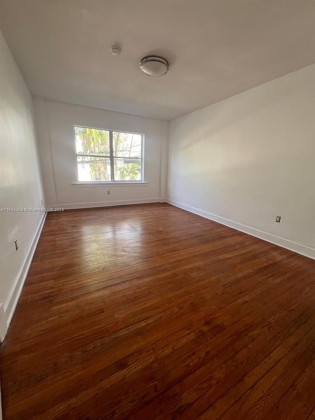 unfurnished room featuring dark hardwood / wood-style floors