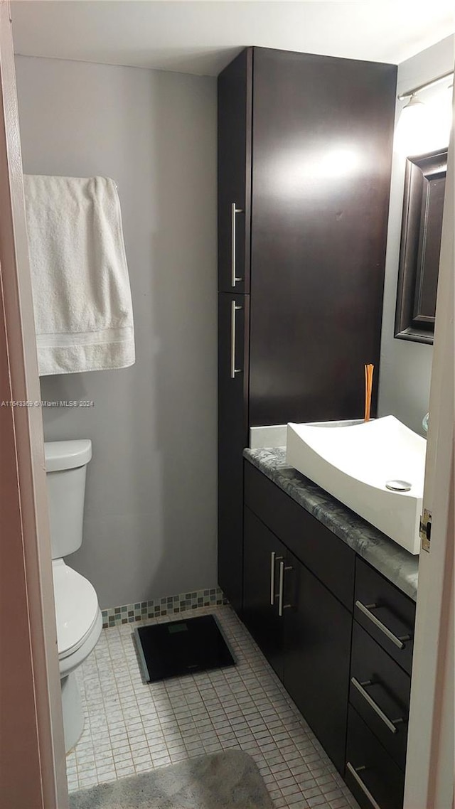 bathroom with vanity, toilet, and tile patterned floors