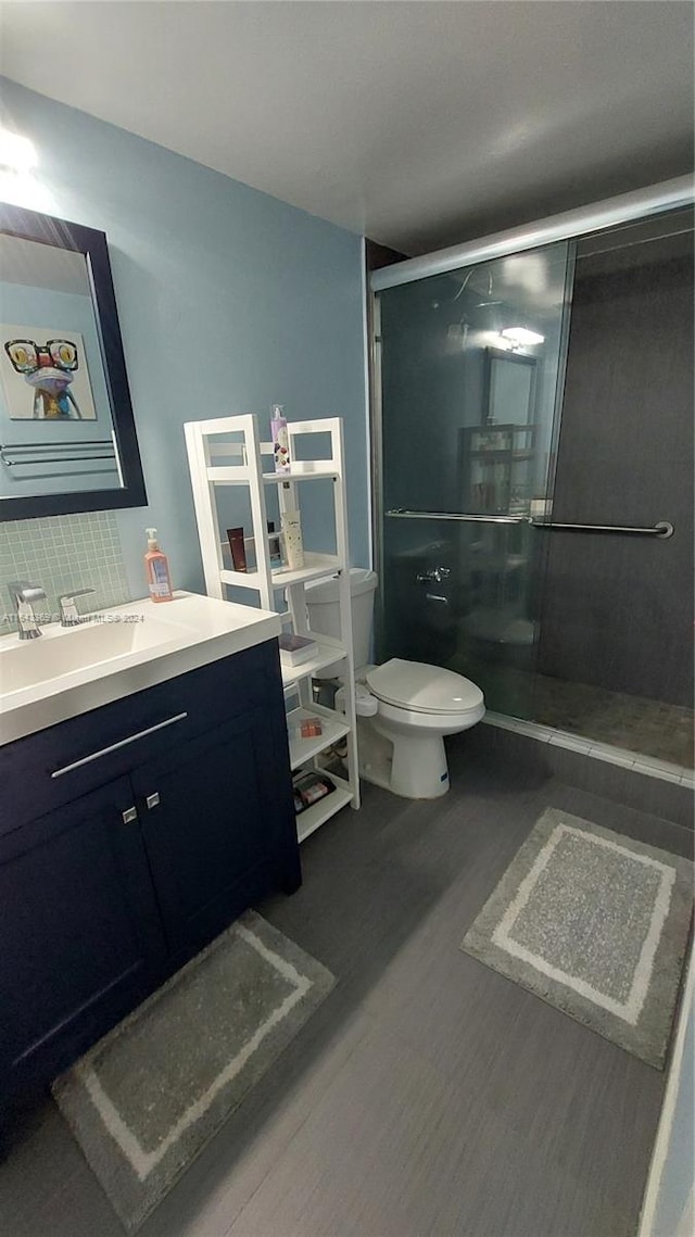 bathroom with vanity, toilet, and an enclosed shower