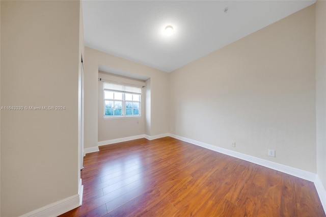 unfurnished room with hardwood / wood-style flooring