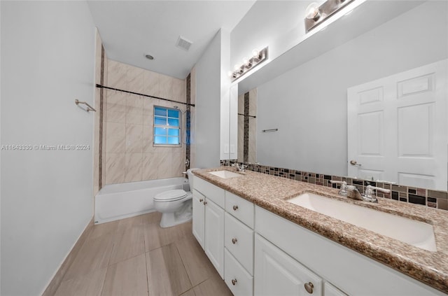 full bathroom with tasteful backsplash, toilet, vanity, and tiled shower / bath