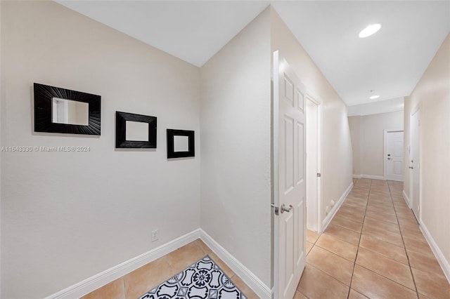 hallway featuring light tile patterned flooring