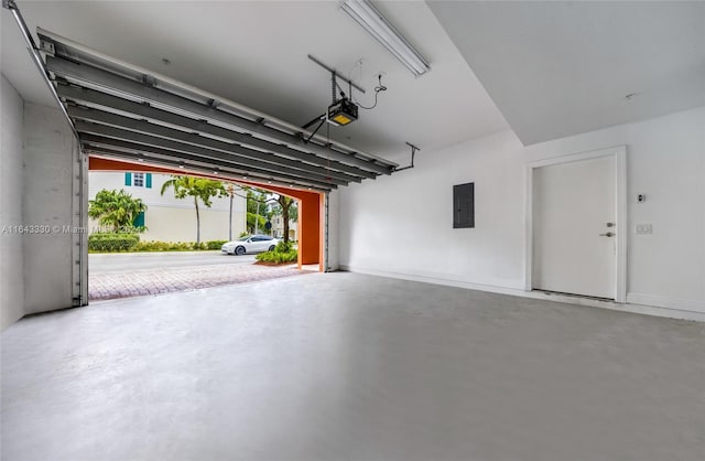 garage featuring electric panel and a garage door opener