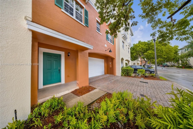 doorway to property with a garage