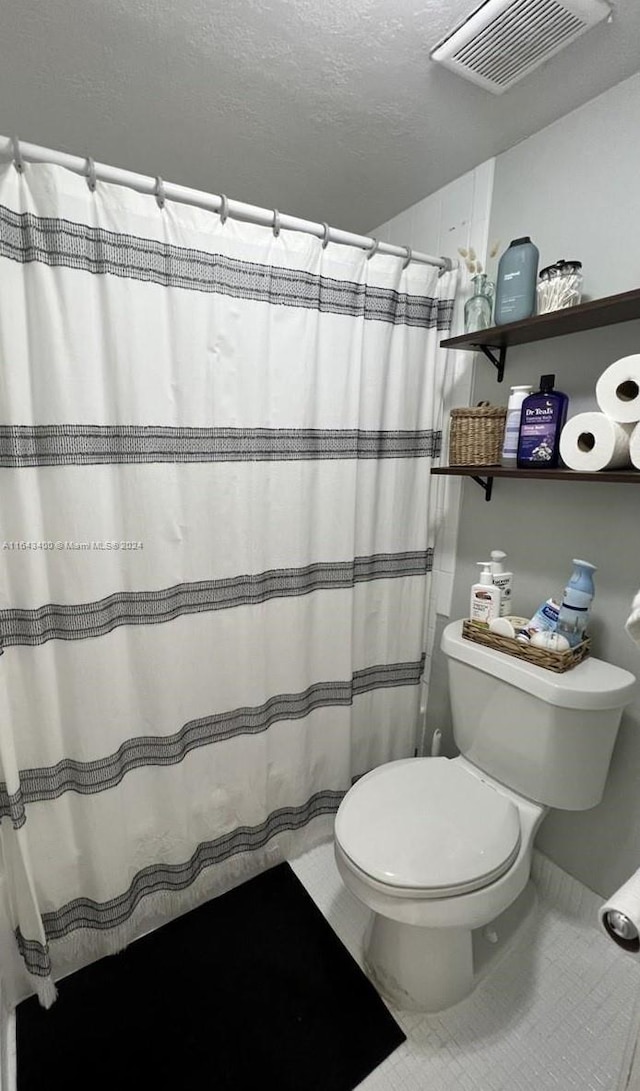 bathroom featuring tile patterned floors and toilet