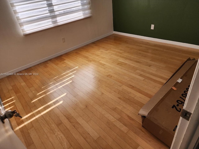 spare room with light wood-type flooring