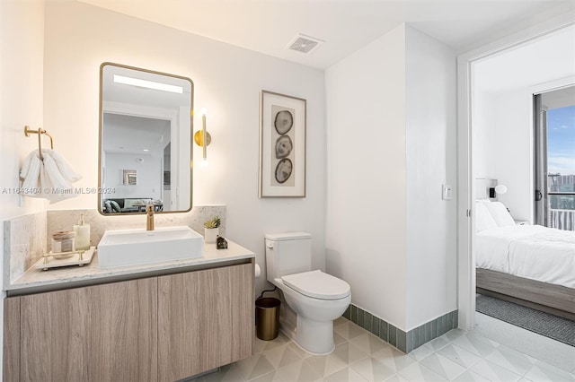 bathroom with vanity and toilet