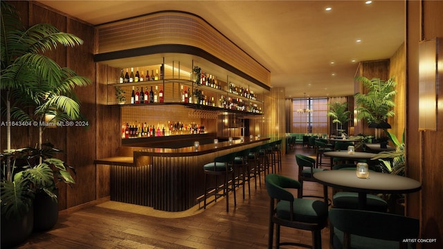 bar with wood walls and hardwood / wood-style floors