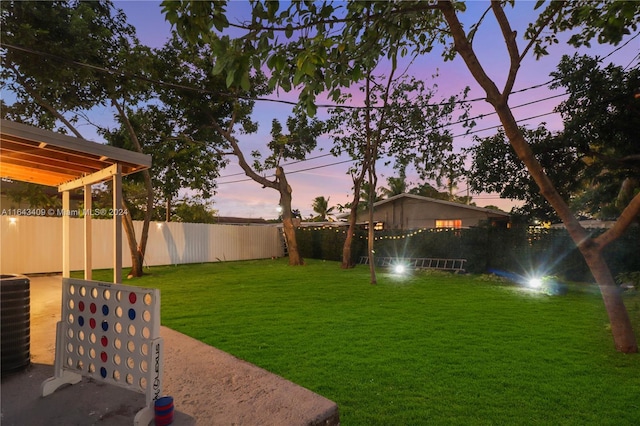 yard at dusk with central air condition unit