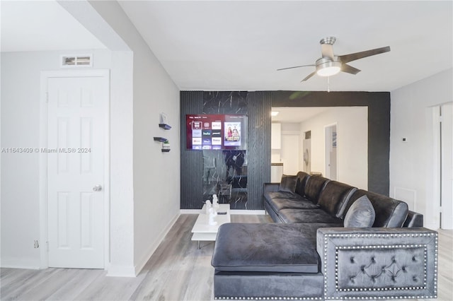 living room featuring ceiling fan and hardwood / wood-style flooring