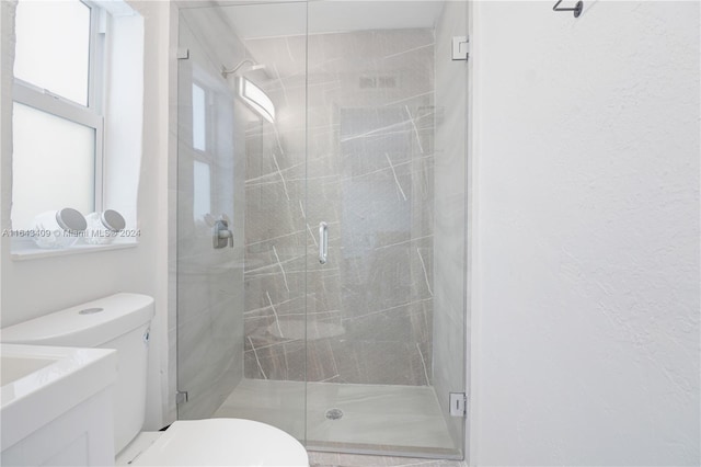 bathroom with walk in shower and toilet