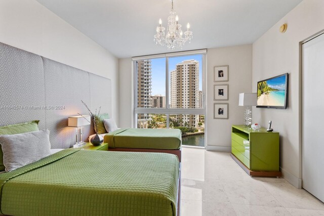 bedroom featuring floor to ceiling windows, a notable chandelier, and light tile patterned flooring