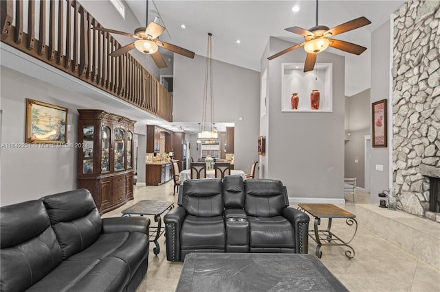 living room featuring ceiling fan, high vaulted ceiling, and light tile patterned floors