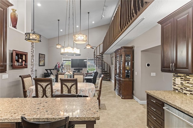 kitchen featuring dark brown cabinetry, light stone countertops, stainless steel dishwasher, tasteful backsplash, and ceiling fan