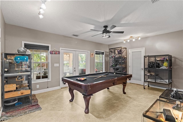 recreation room with ceiling fan, pool table, plenty of natural light, and a textured ceiling