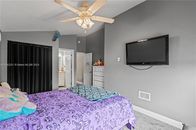 carpeted bedroom with ceiling fan, vaulted ceiling, and connected bathroom