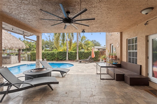 view of patio / terrace featuring ceiling fan and a fenced in pool