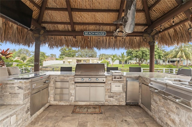 view of patio / terrace featuring ceiling fan, area for grilling, a gazebo, and grilling area