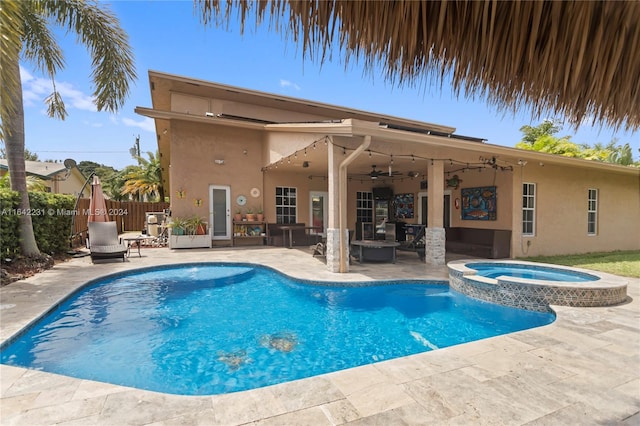 view of swimming pool with an in ground hot tub, a patio area, and ceiling fan