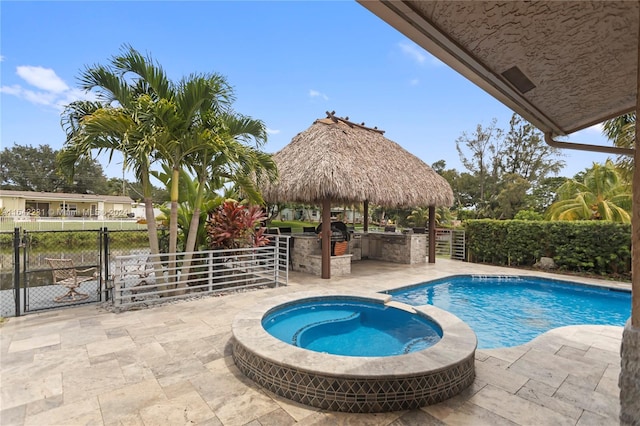 view of swimming pool with a gazebo and an in ground hot tub