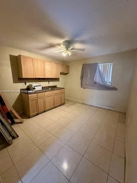 kitchen featuring ceiling fan and light tile patterned floors