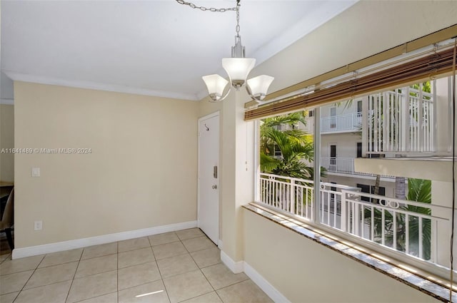 interior space featuring a notable chandelier, a healthy amount of sunlight, and light tile patterned floors