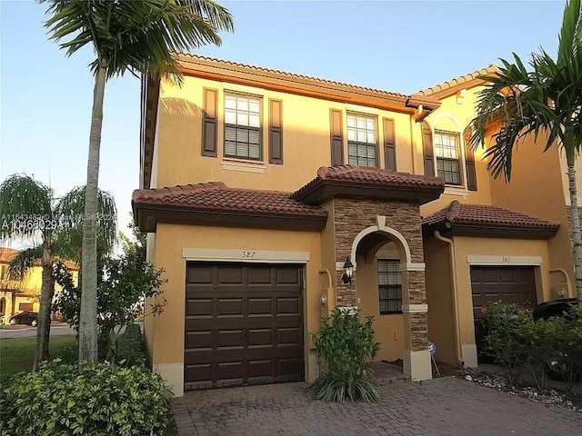 mediterranean / spanish home with a garage