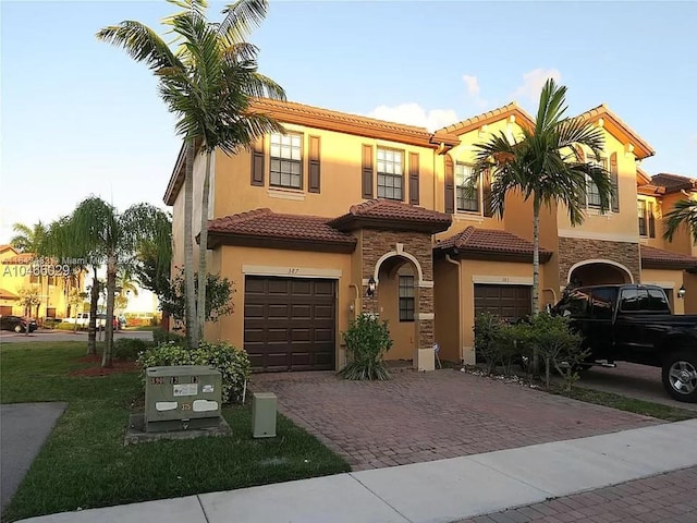 mediterranean / spanish home with a garage