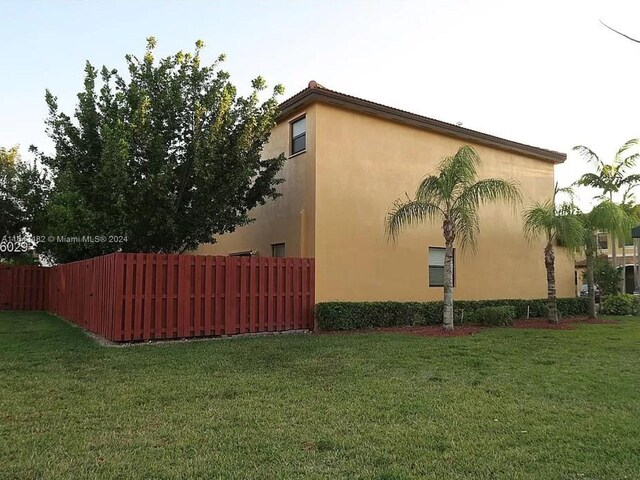 view of side of home featuring a lawn