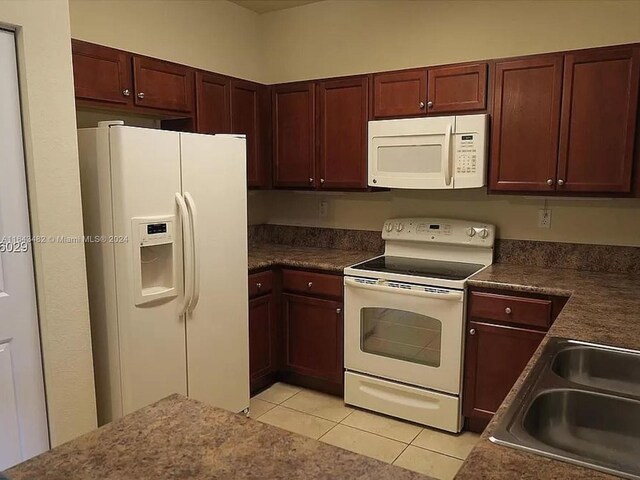 kitchen with sink, white appliances, and light tile patterned floors